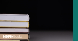 A pile of books in front of a shadowy background.