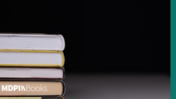 A pile of books in front of a shadowy background.